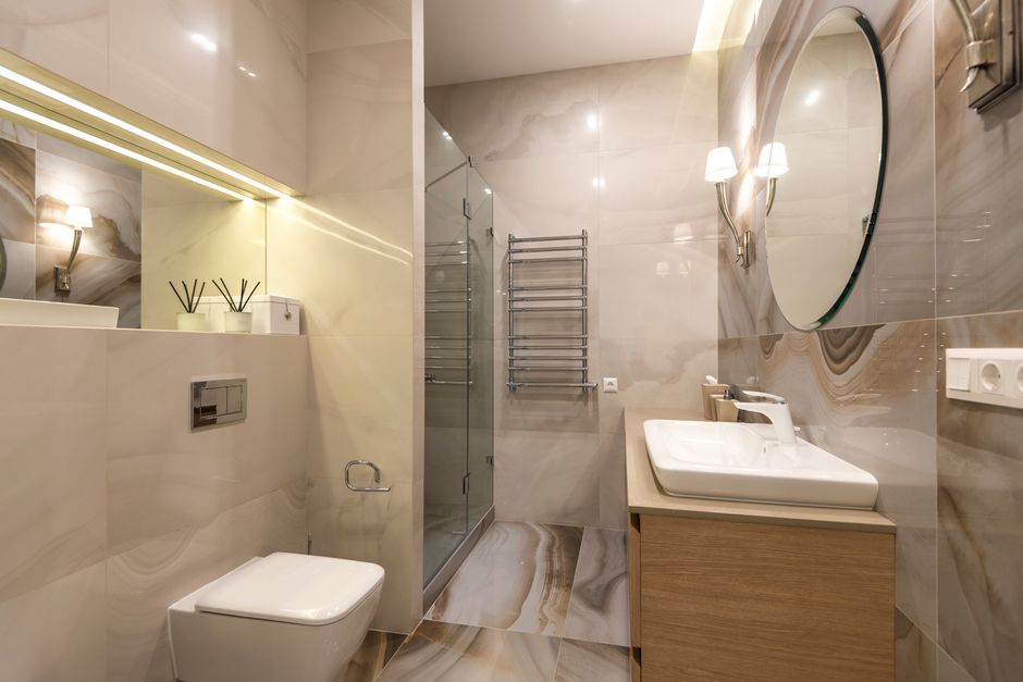 Elegant marble bathroom with a large mirror and modern fixtures